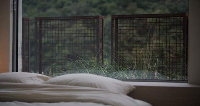 Serene Bedroom with a View of Greenery