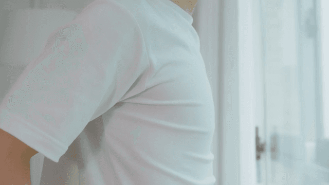 Person Stretching by a Window