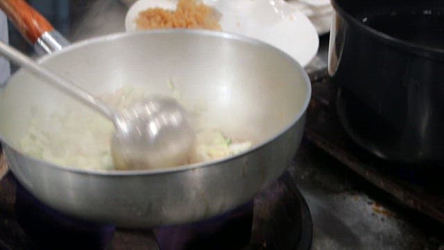 Chopped onions and zucchini fried in a pan