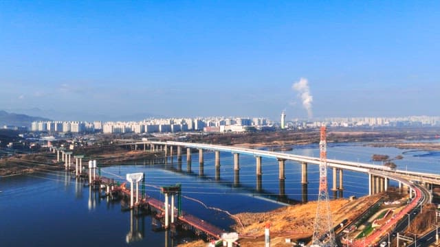 Bridge Connecting Cities with Dense Buildings over a Dam