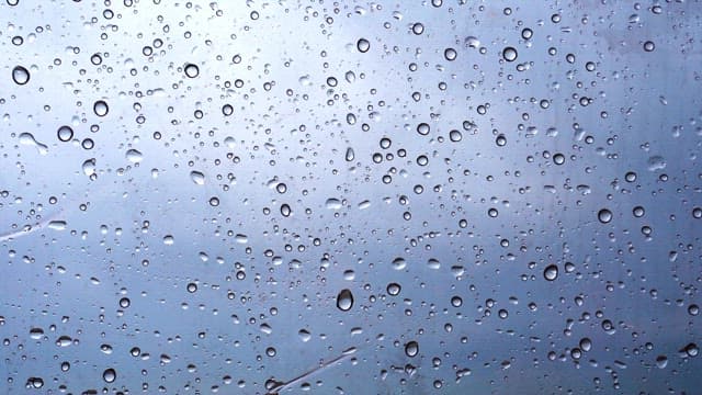 Raindrops on a window on a cloudy and rainy day
