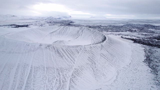 Snow-covered volcanic crater in winter
