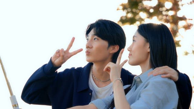 Couple taking selfies in a park