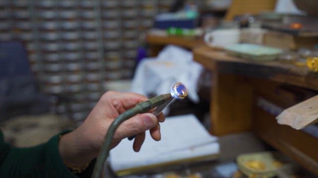 Artisan Crafting Jewelry in Workshop