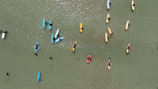 Surfers Floating on a Calm Sea