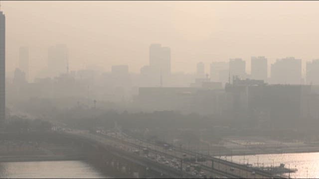 Yellow dusty cityscape with busy traffic