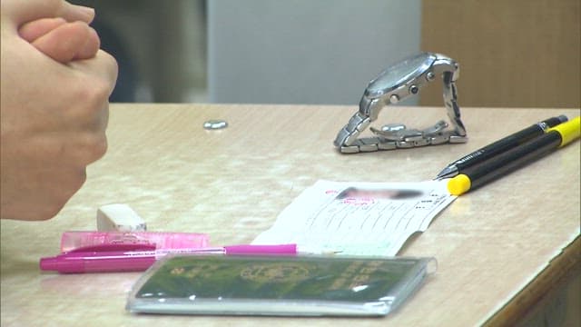 Student's Desk with Test Verification Slips and Writing Utensil on It