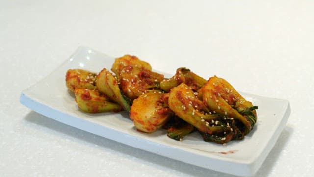 Plate of spicy kimchi garnished with sesame seeds