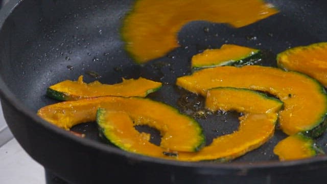 Slices of Pumpkin Being Fried in a Pan
