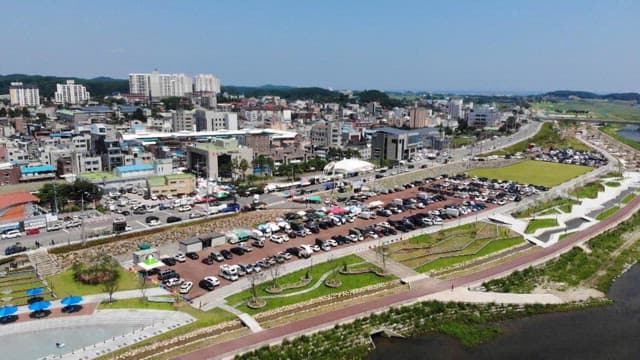 Cars in waterfront parking lot on a sunny day