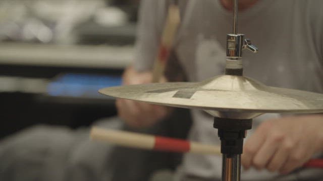Drummer playing the cymbals and snare drum.