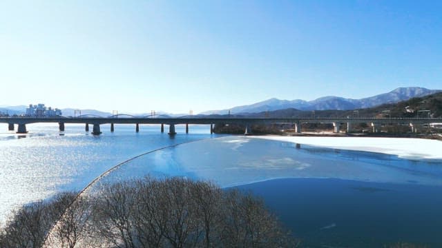 Landscape of Bridges over Frozen River in Winter