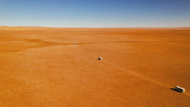Vehicle Crossing the Vast Desert