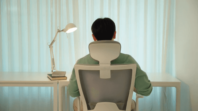 Man sitting at a desk in a calmly lit room