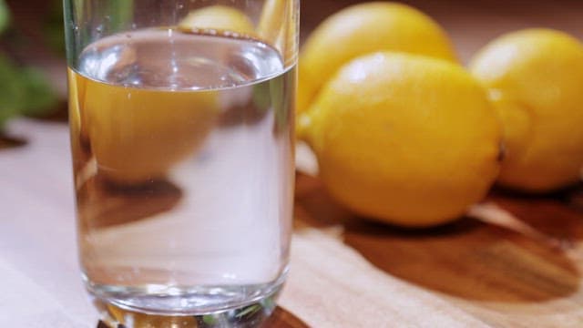 Lemon water being prepared on a table