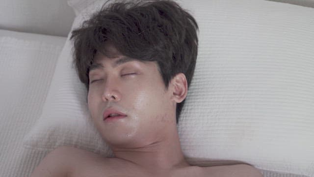 Man waking up abruptly in bed indoors