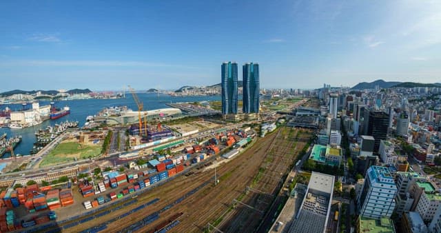 Coastal city skyline with high-rise buildings and port
