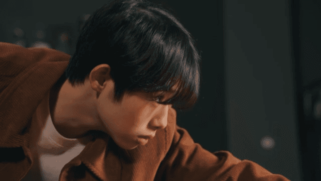 Young man focused on playing pool indoors