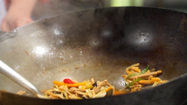 Jjamppong, made by pouring vegetables and meat stir-fried in a spicy sauce in a wok over noodles