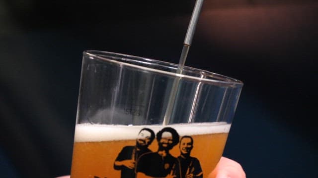 Person pouring a glass of beer