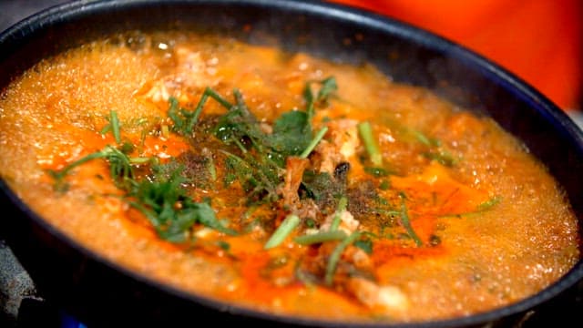 Spicy shaggy sea raven stew boiling in a pot