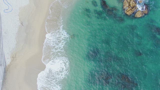 Waves gently crashing on a sandy beach