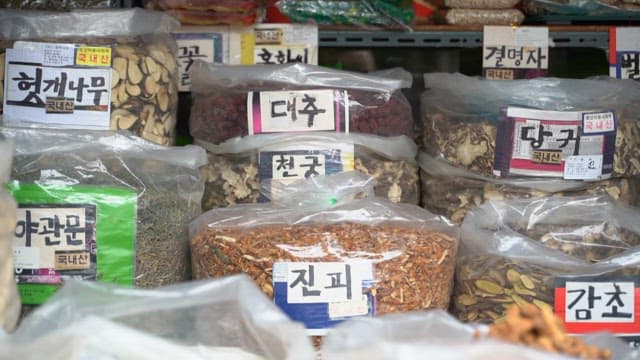 Various dried herbs and roots in a market display