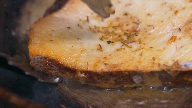 Tuna steaks cooked in hot oil in a frying pan