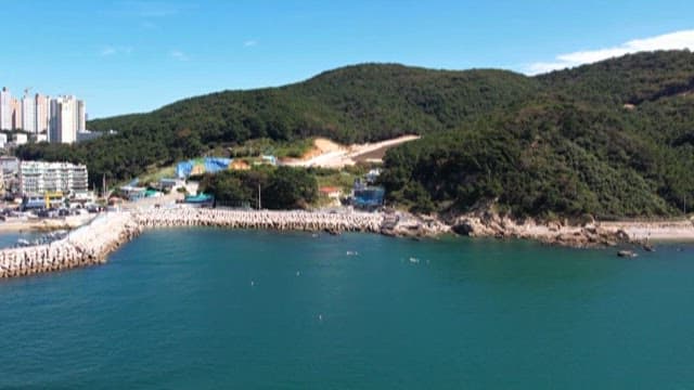 Aerial View of a Coastal Area with Hills and Buildings