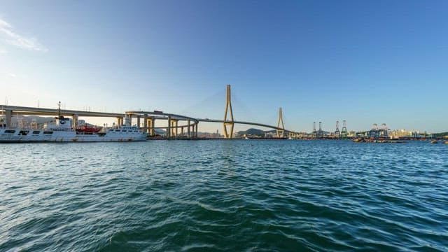 Busy Busanhangdaegyo Bridge and serene sea from day to night