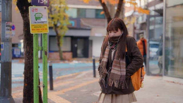 Student waiting at a bus stop