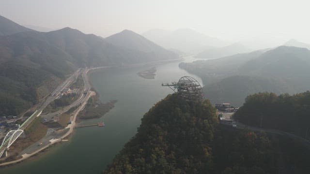 Serene River Flowing Along the Green Mountainsides