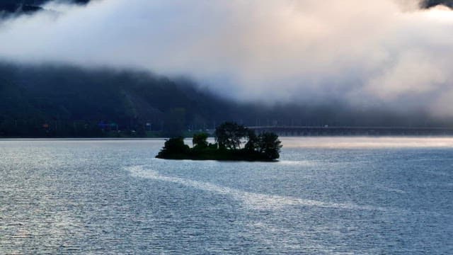Small island in a misty river