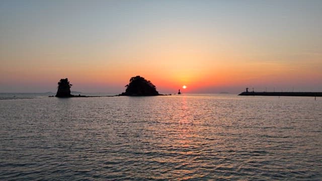 Sunset over the Sunset with the Silhouette of a Small Island