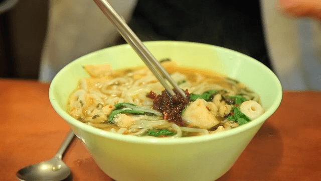 Bowl of udon with spicy sauce and fish cake