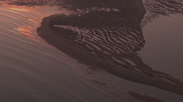 Sunset over a serene tidal flat