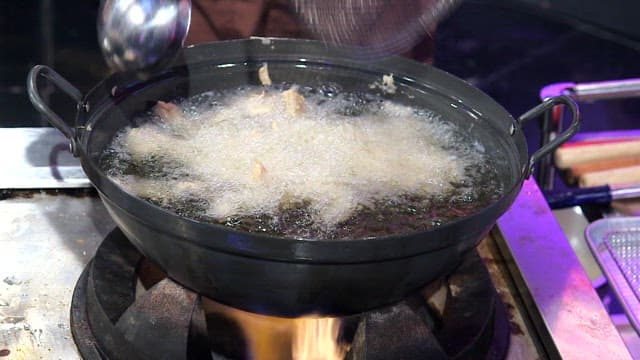 Frying pork in hot oil