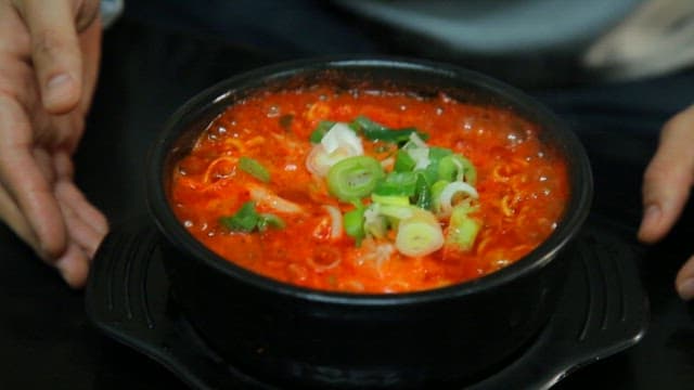 Spicy seafood ramyeon boiling in hot pot