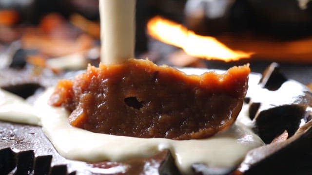 Preparing fish-shaped pastry with wheat batter and sweet red bean filling