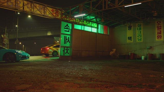 Woman working at a car wash at night