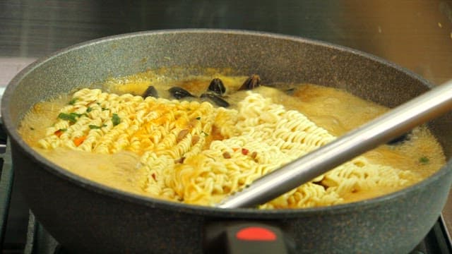Cooking ramen with mussels in a pot