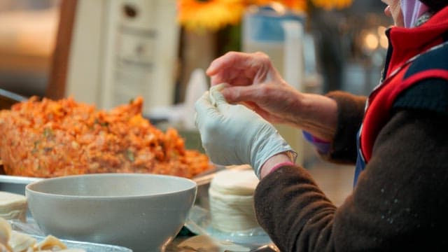 Woman making dumplings with kimchi filling