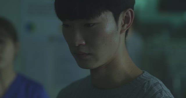 Man crying with a depressed expression in a dark room