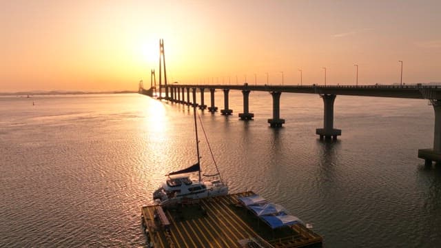 Bridge over calm waters at sunset