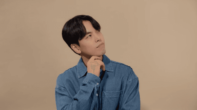 Man in denim shirt deep in thought