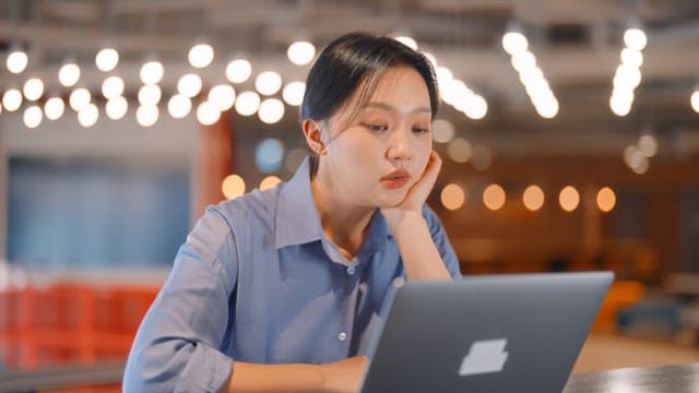 Woman working on a laptop in a modern office