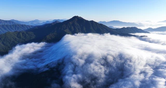 Mountain peak surrounded by clouds