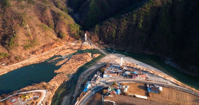 Aerial View of a Suspension Bridge Over a River