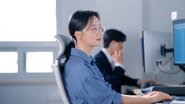 Woman wearing glasses smiling in the office