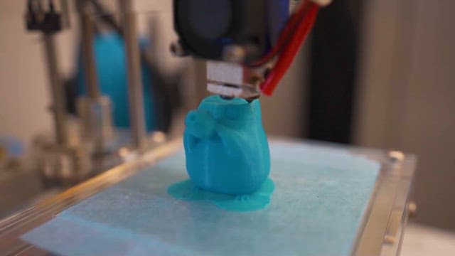 3D Printer Creating a Blue Object